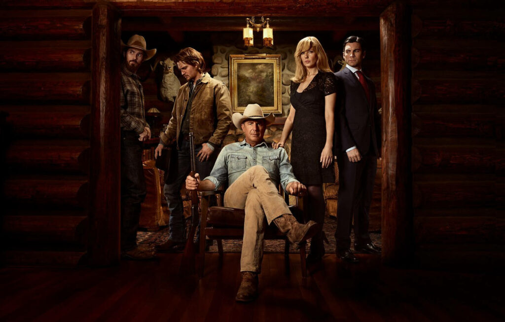 Stunning Yellowstone Family Portrait Wallpaper in Rustic Lodge Setting