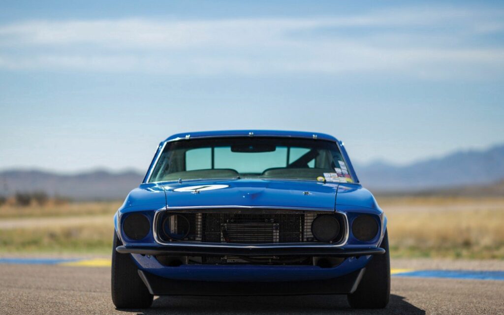 1969 Ford Mustang Wallpaper: Bold Blue Beauty in Serene Landscape
