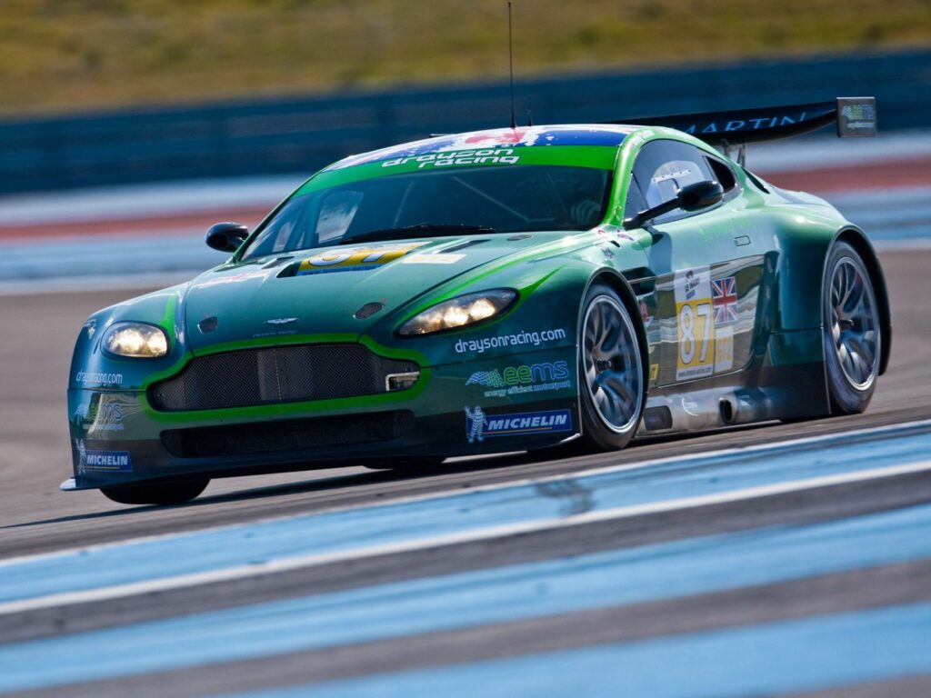 2009 Aston Martin V8 Vantage in Vibrant Green on Racetrack Wallpaper