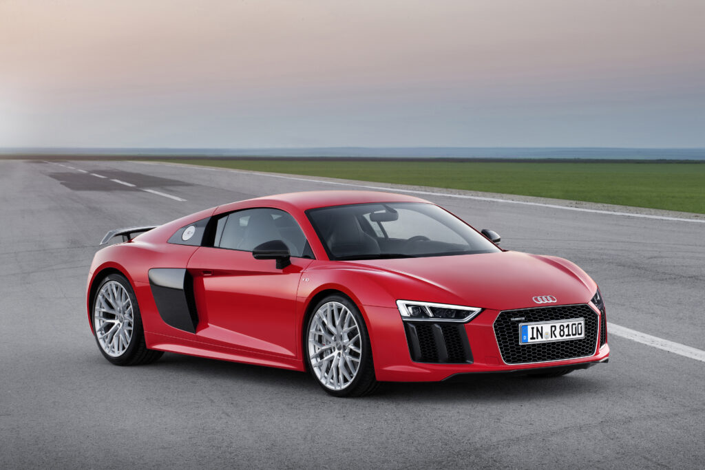 Vibrant Red 2015 Audi R8 V10 Wallpaper with Scenic Background