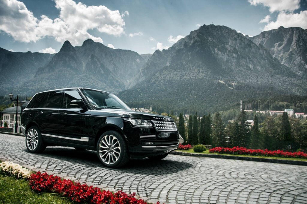 Stunning Black Range Rover Wallpaper with Majestic Mountain Background