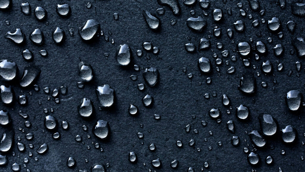Immersive 3D Water Droplets Wallpaper on Dark Surface Background