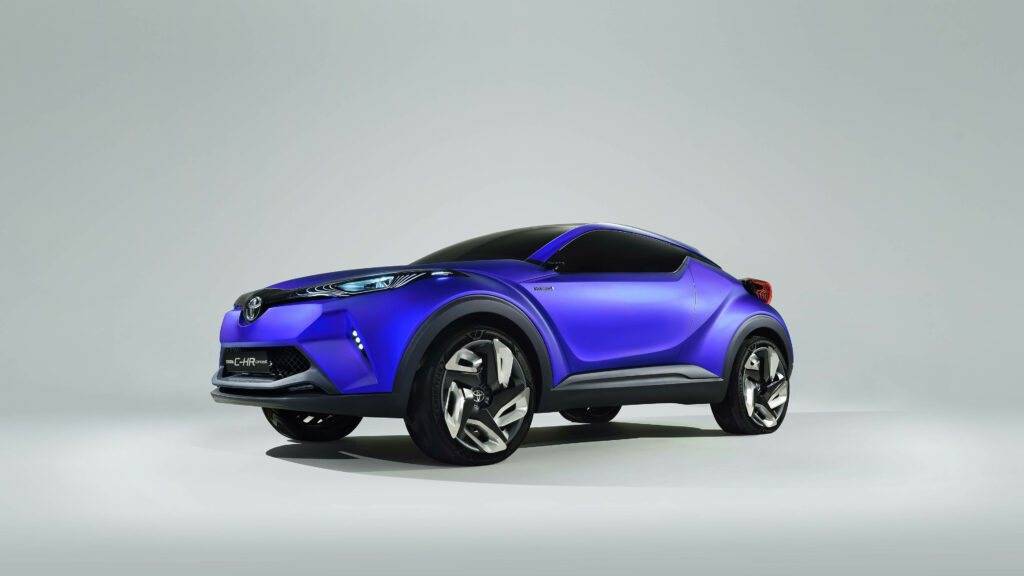 Side view of blue Toyota CH-R in 4K showcasing modern design and bold curves on plain background Wallpaper