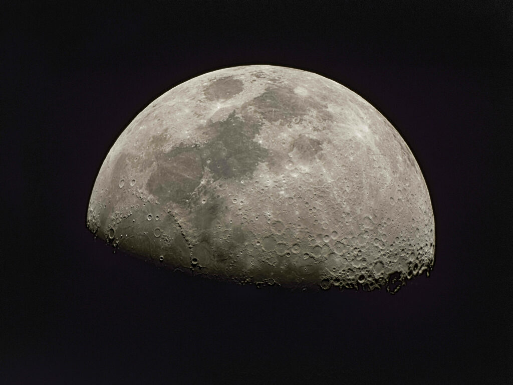 Detailed 4k close-up of the Moon's craters and textures against a dark space backdrop. Wallpaper