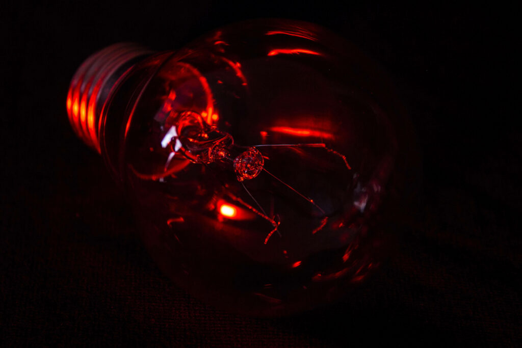 Vibrant Red Lightbulb in 4K Ultra HD Wallpaper | Dramatic Background