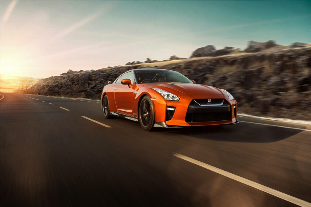 Stunning 4K Wallpaper: Orange Nissan GT-R at Sunset Scenic Road