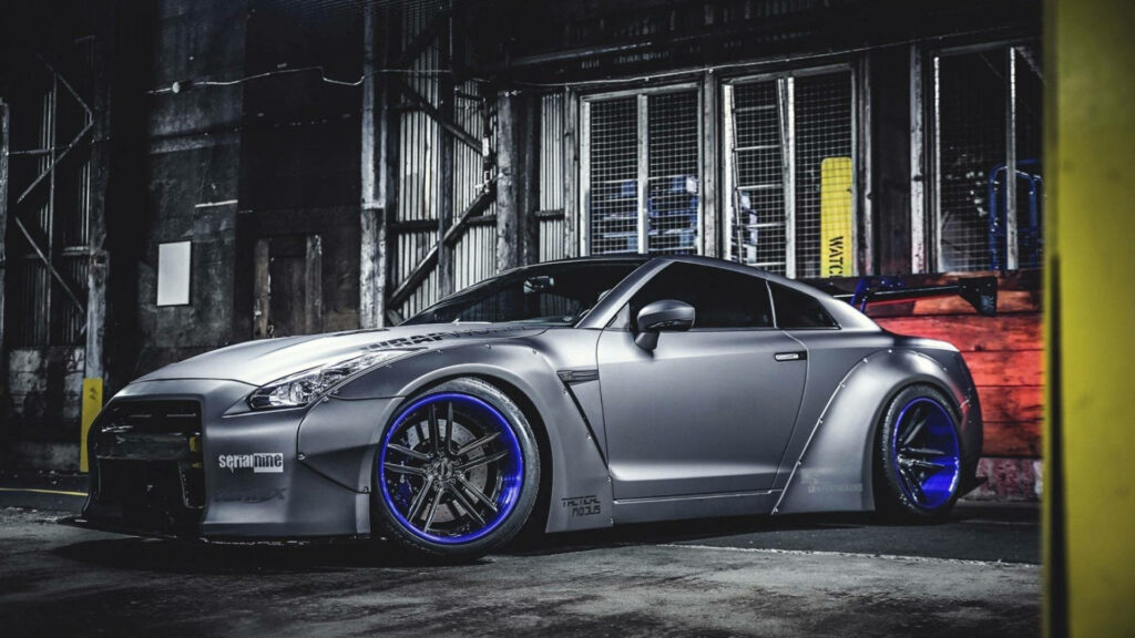 4K Nissan GT-R Wallpaper: Sleek Gray Car with Blue Rims in Urban Setting