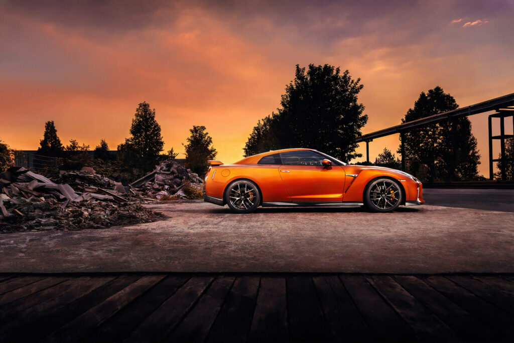 Stunning Orange Nissan GT-R 4K Wallpaper Against Vibrant Sunset
