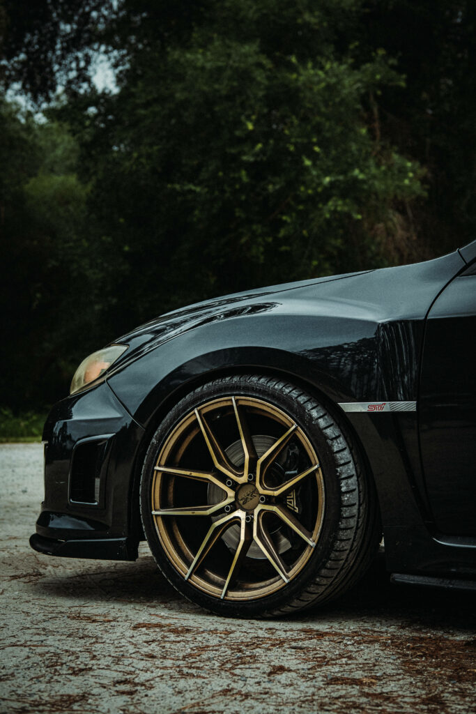 Stunning Subaru WRX STI 4K Wallpaper with Gold Rims in Nature