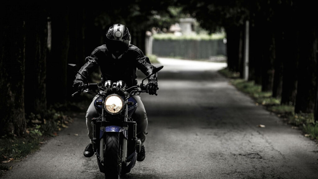 4K Wallpaper: Mysterious Rider on Dark Motorcycle in Cinematic Vibe