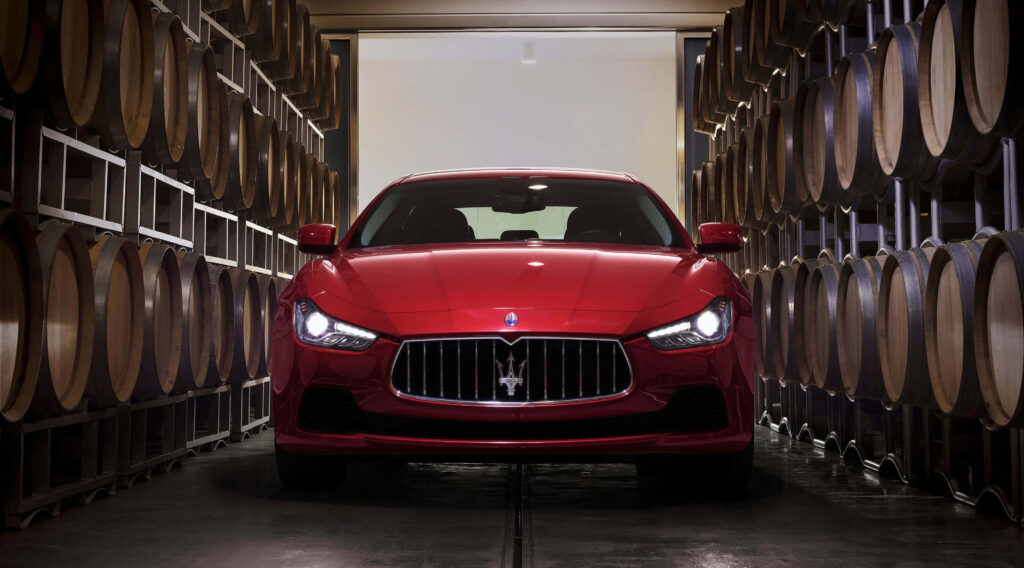 Elegant 4K Wallpaper: Red Maserati in Rustic Barrel Cellar