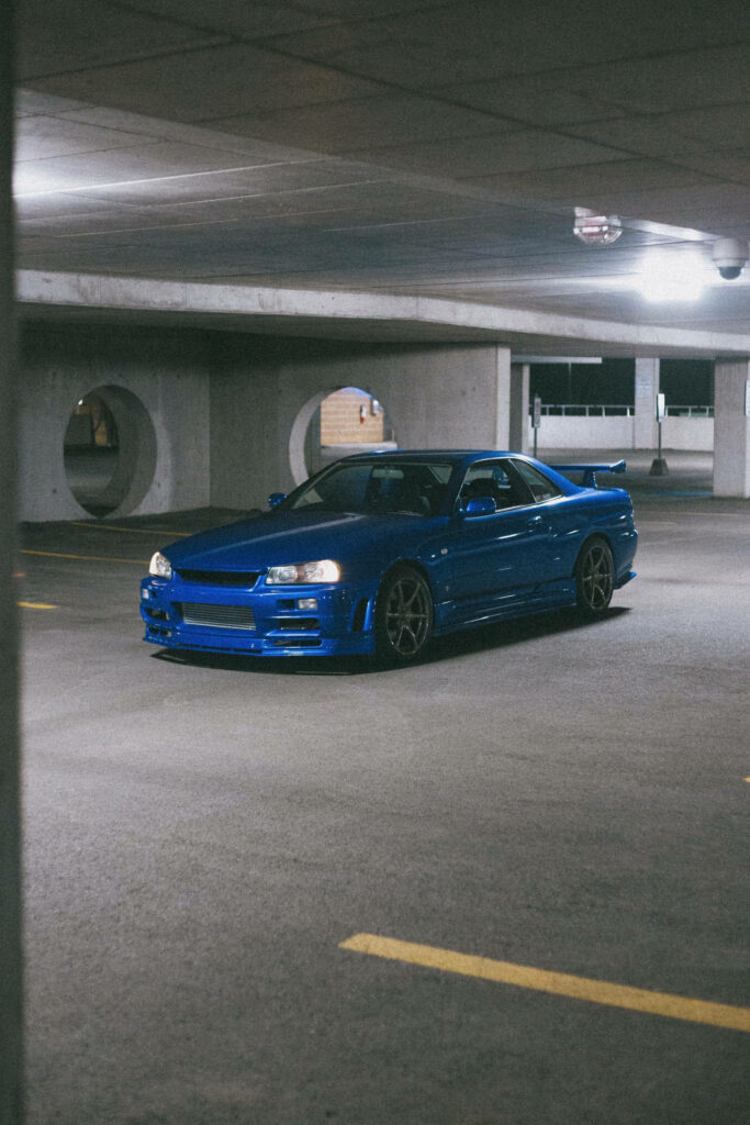 Vibrant Blue Nissan GT-R 4K Wallpaper in Dimly Lit Garage