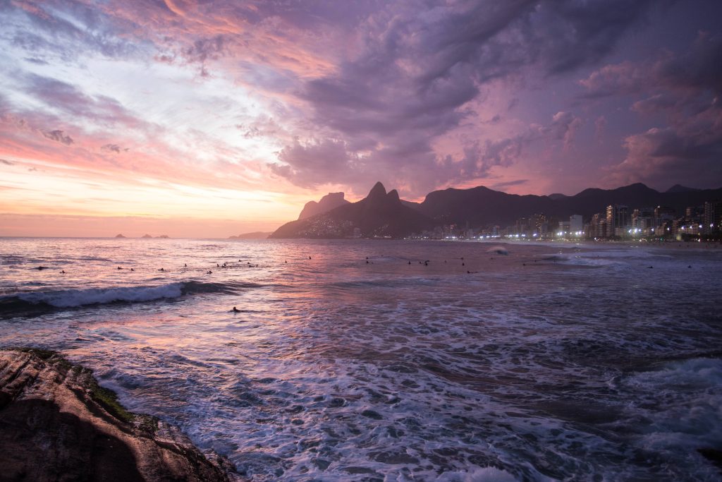 8K coastal Rio de Janeiro wallpaper with Morro Dois Irmãos vibrant purple sunset ocean view