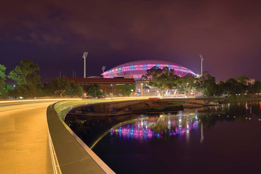 Adelaide Oval night view vibrant lights reflecting on calm waters serene cityscape wallpaper