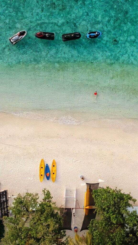 Serene Aerial Beach View: Kayaks on Turquoise Water - iPhone Wallpaper