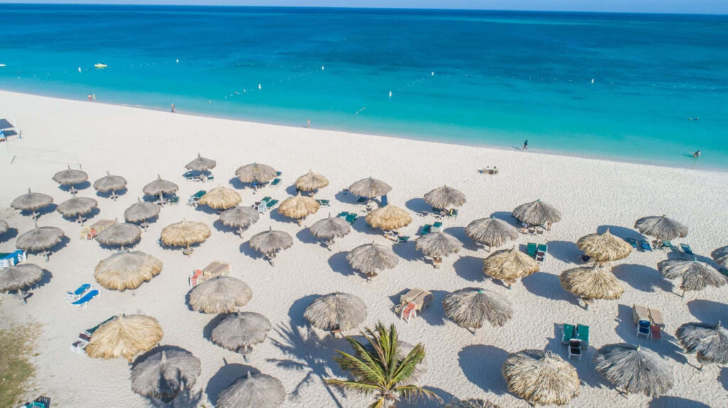 Stunning Aerial Beach Wallpaper: Pristine Sand & Straw Huts