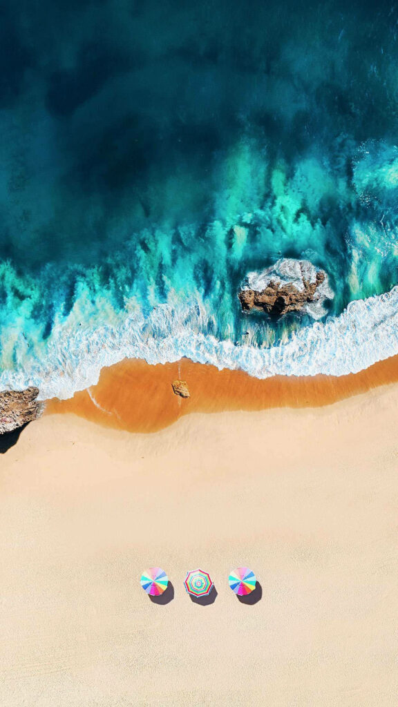 Stunning Aerial Beach Wallpaper: Turquoise Waves & Colorful Umbrellas