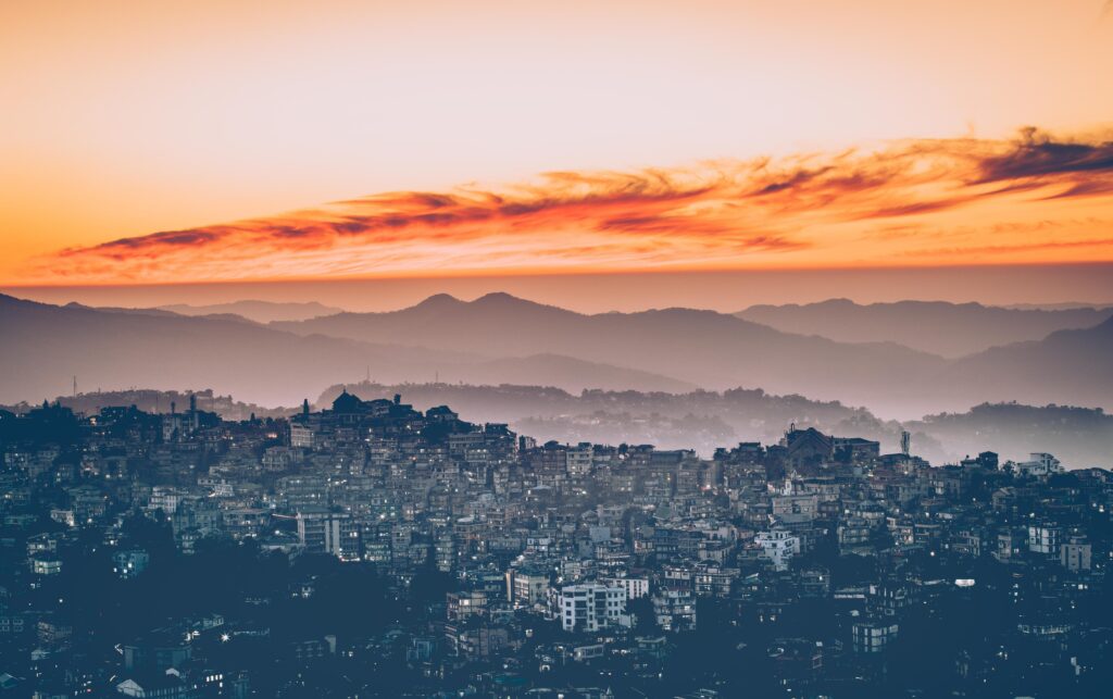 Stunning Foggy Cityscape Wallpaper at Sunset - Serene Background