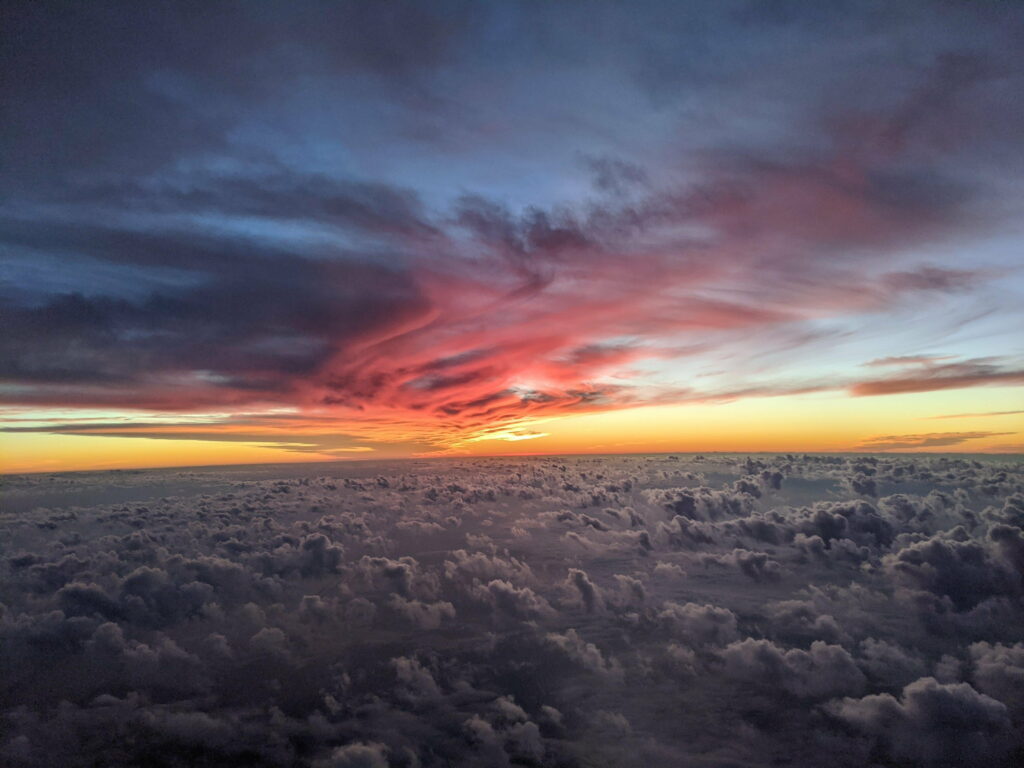 Serene Aerial View of Fluffy Clouds at Vibrant Sunset - Nature's Beauty Wallpaper