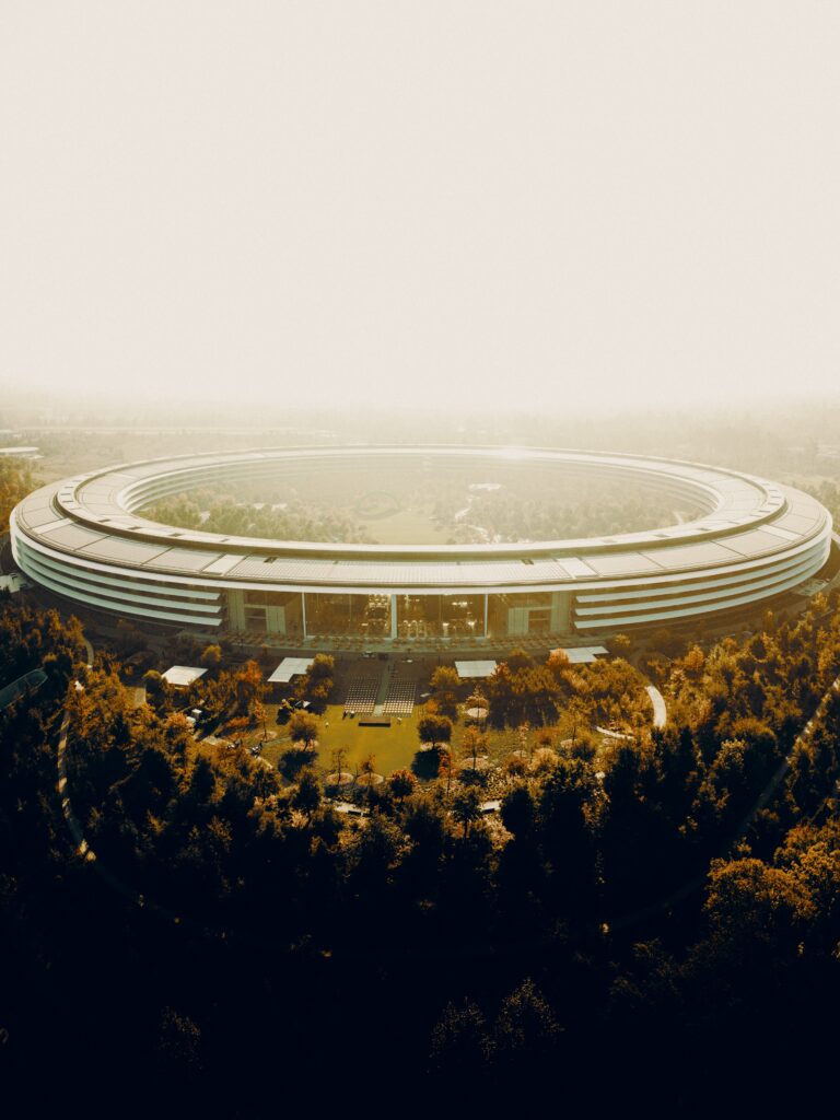 Stunning Aerial Wallpaper: Modern Circular Building in Lush Greenery