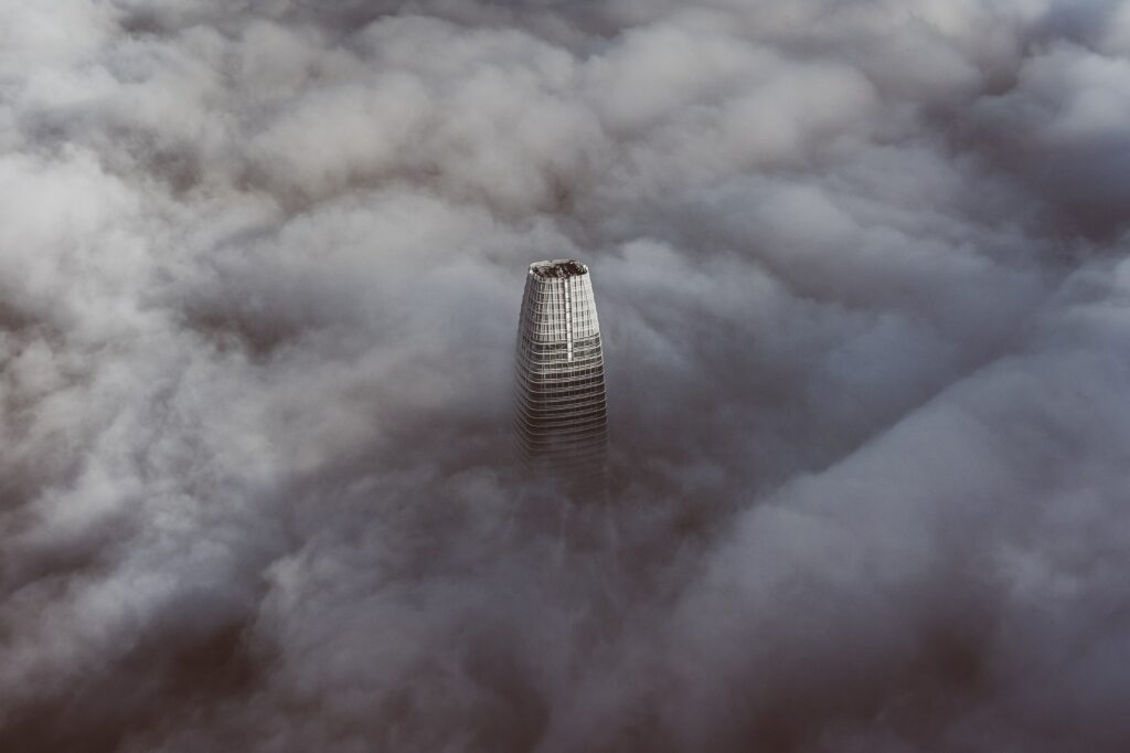 Stunning Aerial Wallpaper of Skyscraper Above Dreamy Clouds