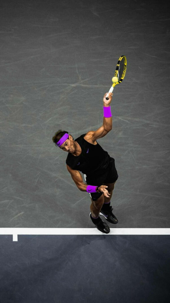 Aerial Wallpaper of Rafael Nadal's Iconic Serve on Dark Court