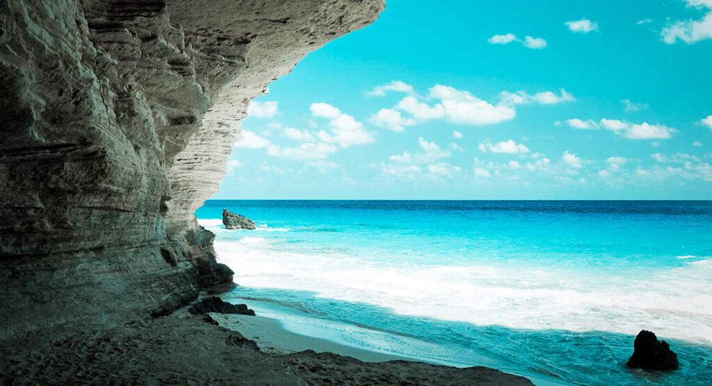 Stunning Ageeba Beach Wallpaper: Turquoise Waters & Coastal Rocks