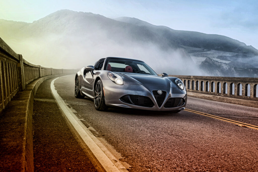 Stunning Alfa Romeo 4C Spider on Scenic Mountain Road Wallpaper