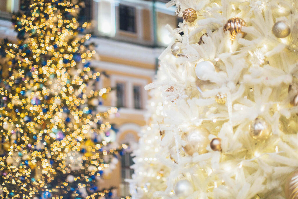 Elegant All-White Christmas Tree with Twinkling Holiday Decor Wallpaper