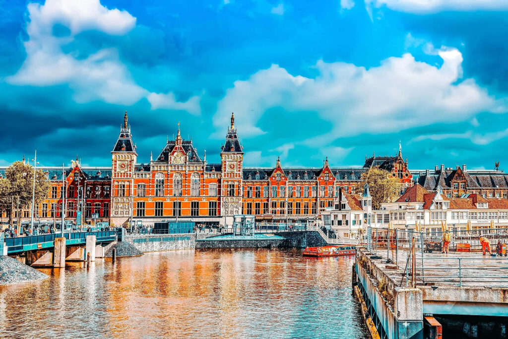Stunning Amsterdam Canals Wallpaper: Historic Architecture & Blue Sky