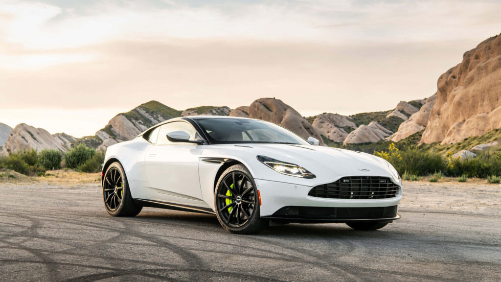 Luxury Aston Martin DB11 Wallpaper: Scenic Rocky Hills & Sky