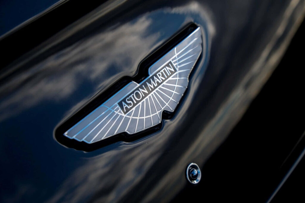Elegant Aston Martin Logo Close-Up: Luxury Wallpaper Background