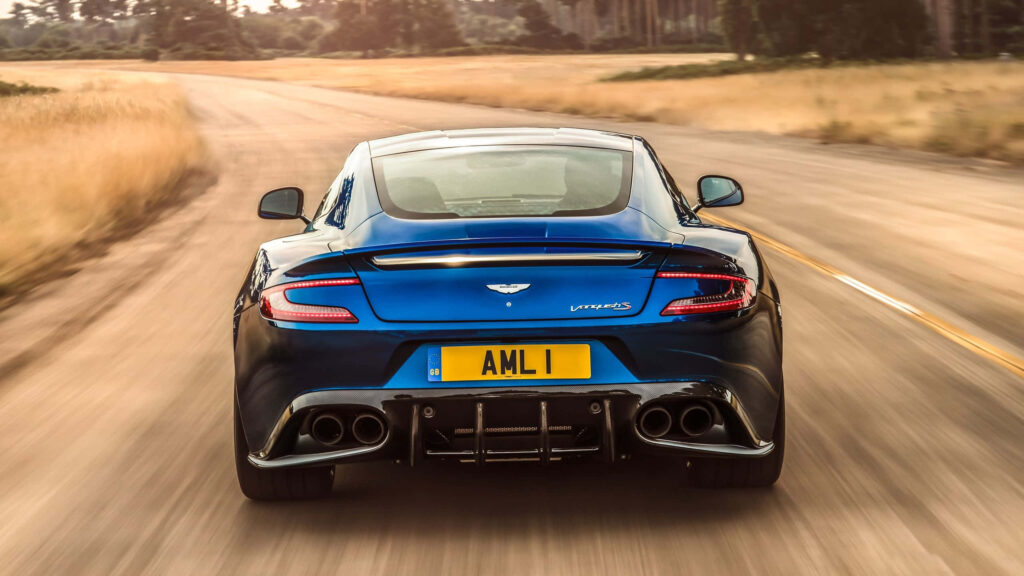 Aston Martin Vanquish Wallpaper: Sleek Motion on Countryside Road