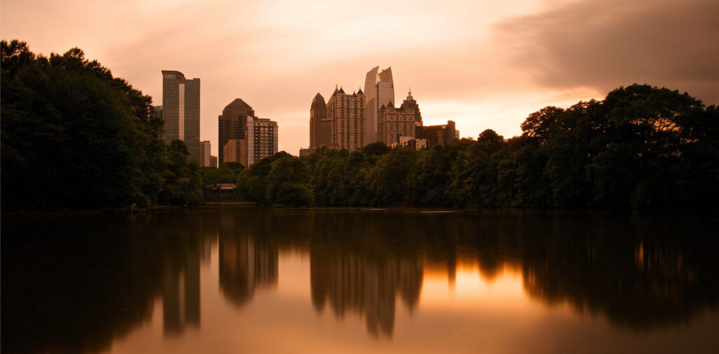 Atlanta Skyline Sunset Wallpaper: Iconic City Reflected on Calm Lake