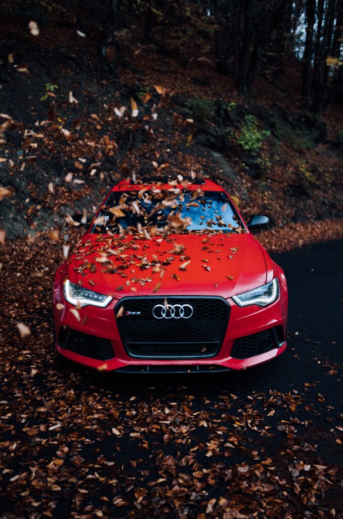 Red Audi Car Front View in Vibrant Autumn Background Wallpaper
