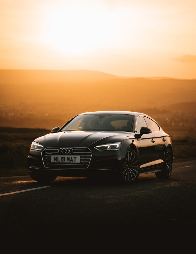 Elegant Audi at Sunset: Stunning Wallpaper with Golden Hues