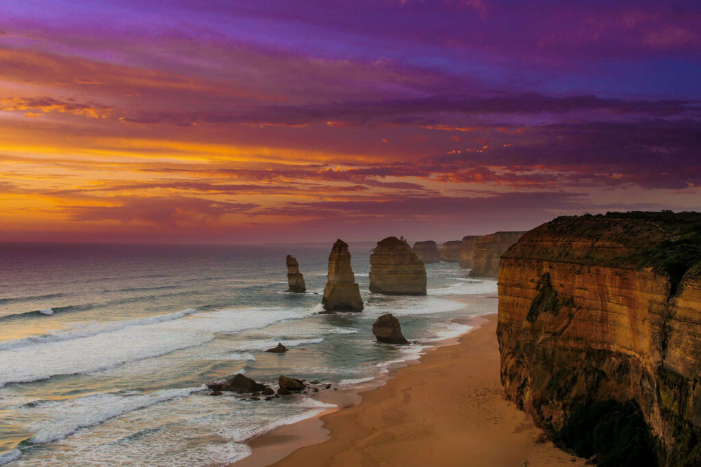Stunning Sunset Over Pristine Australian Beach with Rock Formations Wallpaper
