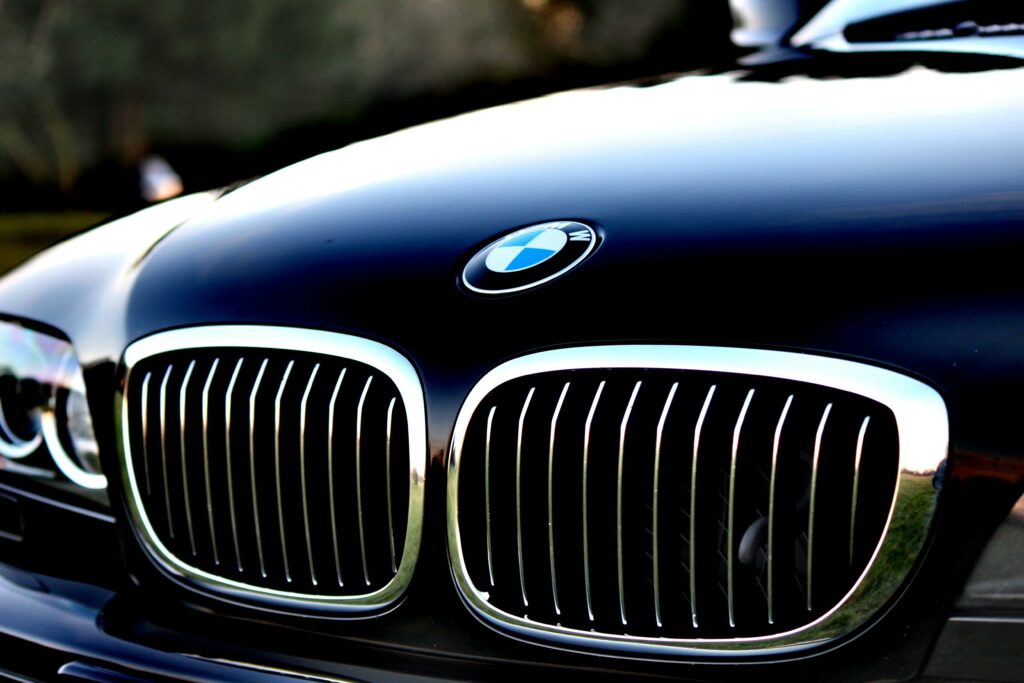 Close-Up BMW Car Hood Wallpaper with Iconic Logo and Glossy Finish