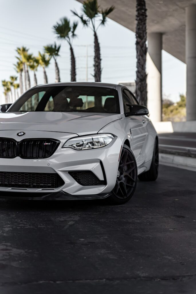 Stylish White BMW M2 Under Modern Overpass | Luxury Car Wallpaper