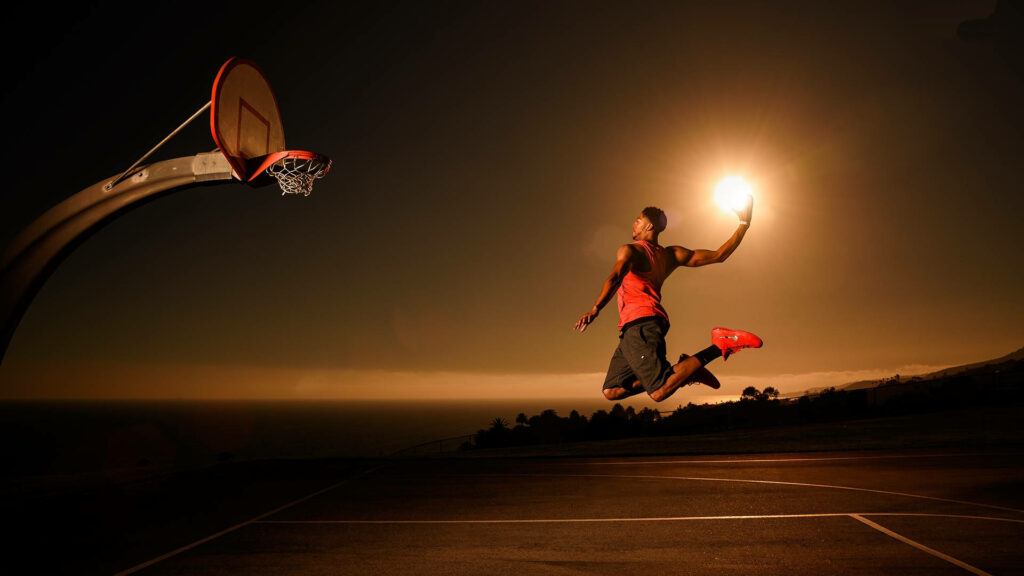 Sunset Basketball Dunk Wallpaper: Iconic Player at Dramatic Court
