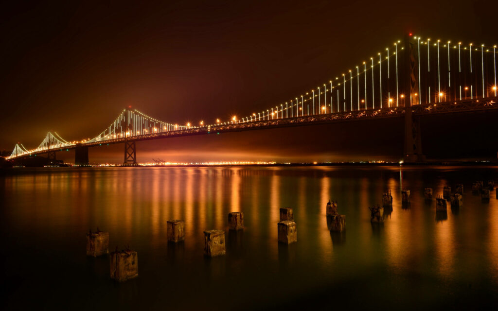 Serene Bay Bridge Nighttime Photo Wallpaper: Illuminated Calm Waters
