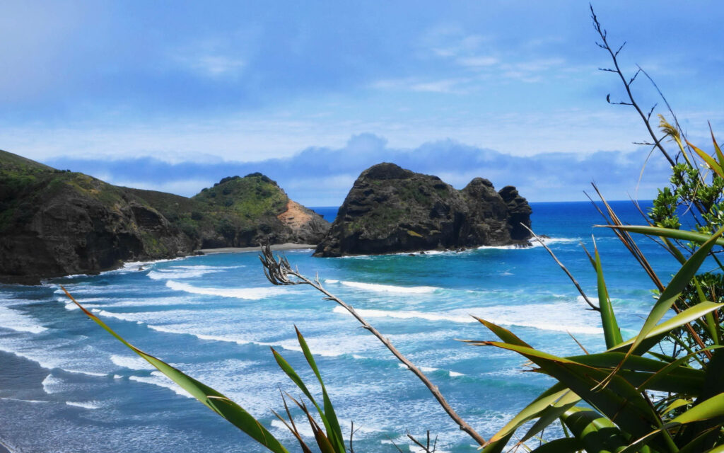 “Stunning Beach Wallpaper: Dramatic Rocks & Azure Waves Scene”