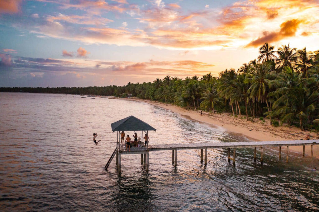 Tropical Beach Sunset Wallpaper with Gazebo and Palm Trees