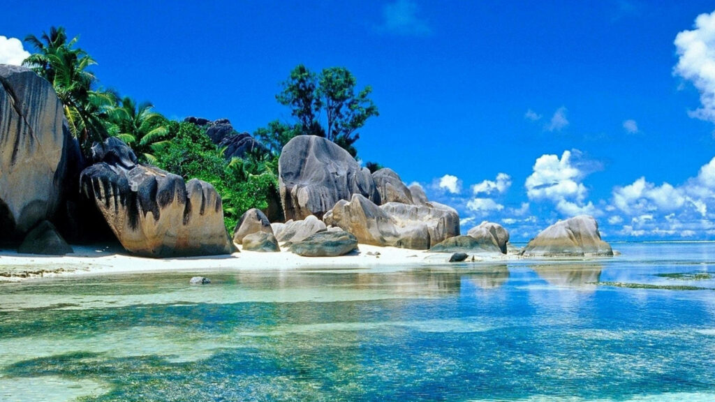 Tropical Beach Scene: Clear Waters & Sandy Shore Wallpaper