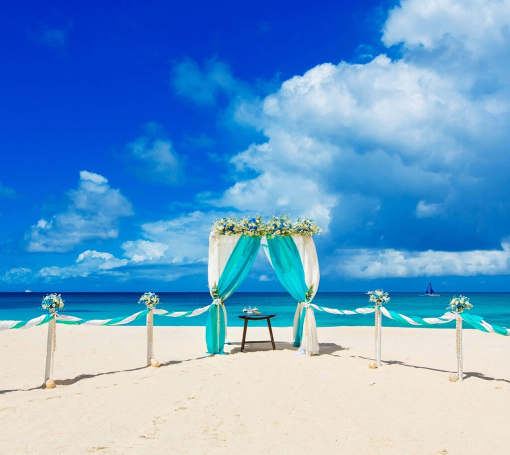 Stunning Beach Wedding Setup: Floral Arch & Ocean Backdrop Wallpaper
