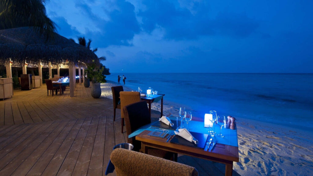 Serene Twilight Beachfront Dining Wallpaper with Ocean View