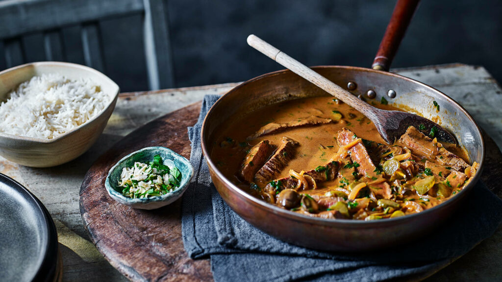 Elegant Beef Stroganoff in Rustic Pan with Rice & Herbs - Wallpaper