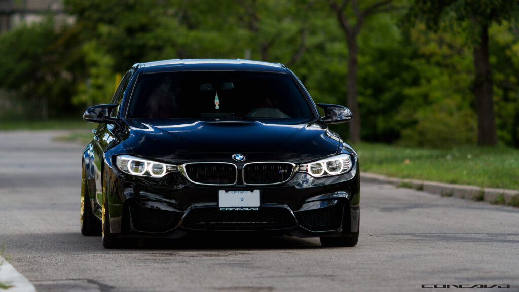 Sleek Black BMW M4 Front View Wallpaper - Bold & Glossy Design