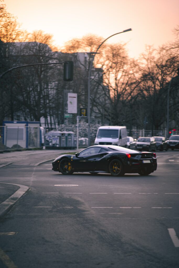 Elegant Black Ferrari 458 Italia at Sunset: Urban Luxury Wallpaper
