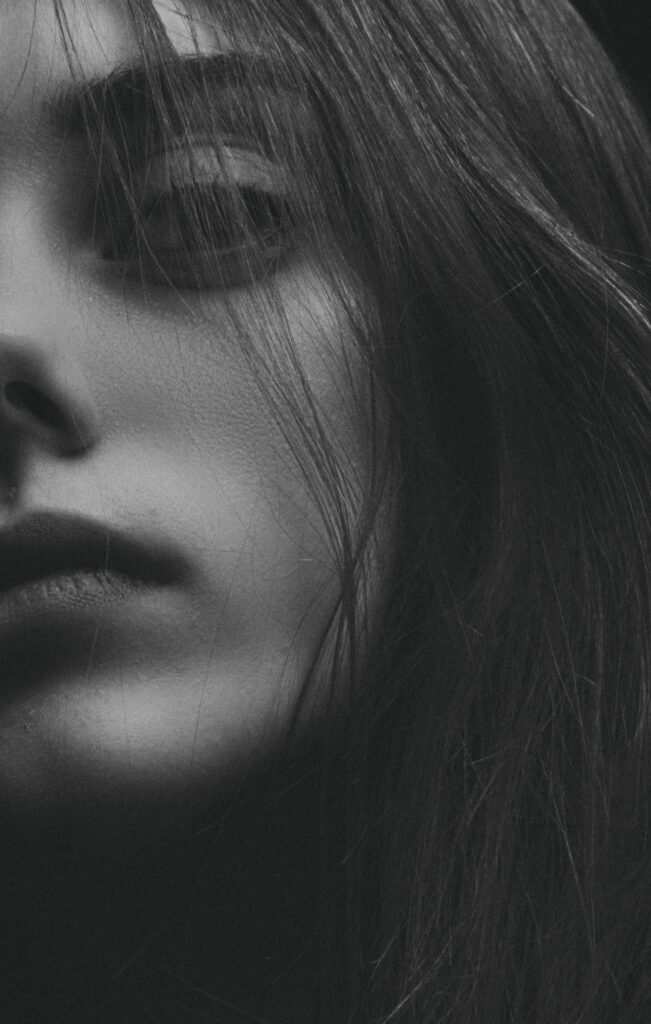 Dramatic Black and White Woman's Portrait Wallpaper with Intense Gaze